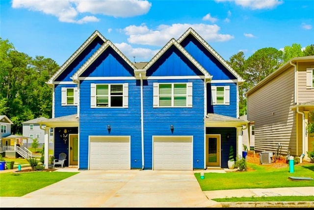 view of front of house with central AC unit, a garage, and a front lawn