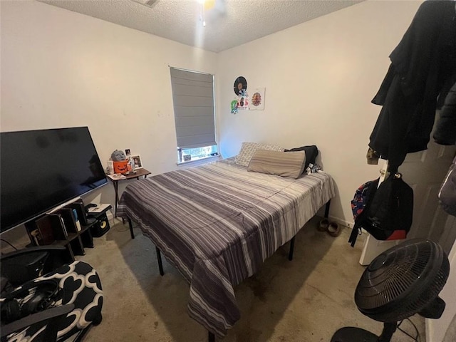 bedroom with light carpet and a textured ceiling