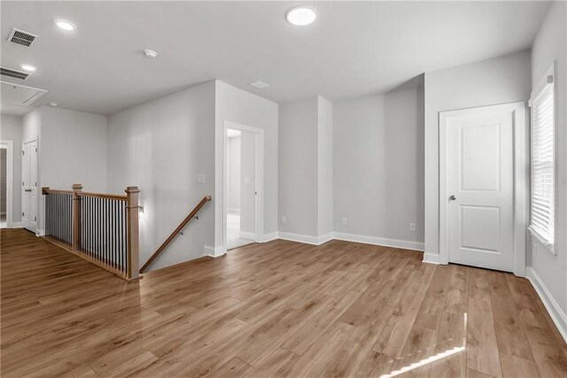 unfurnished bedroom with ceiling fan, a raised ceiling, ornamental molding, and multiple windows