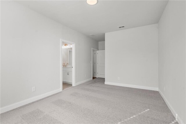 empty room with light colored carpet