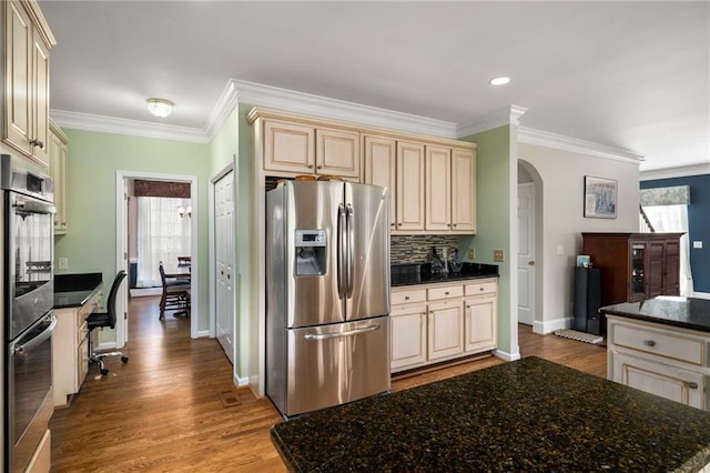 kitchen with appliances with stainless steel finishes, a wealth of natural light, light wood-type flooring, and cream cabinets