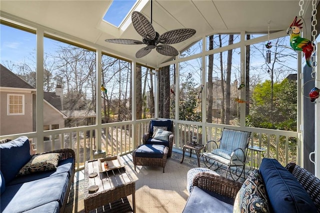 sunroom with ceiling fan and vaulted ceiling with skylight