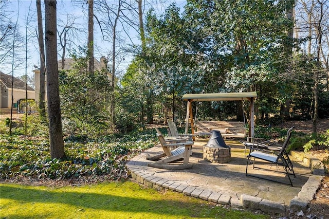 view of yard featuring a fire pit and a patio