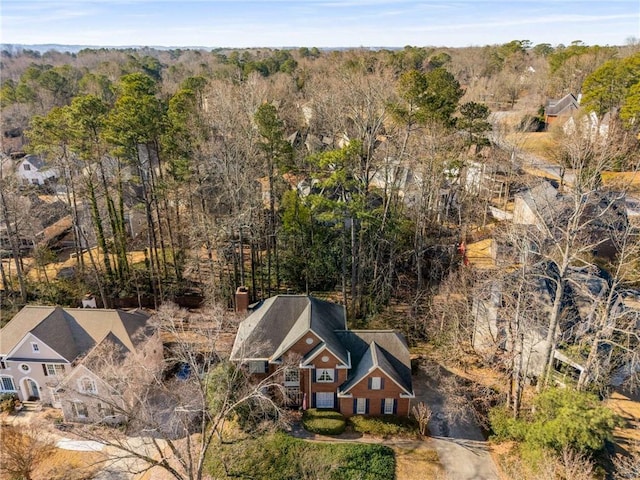 birds eye view of property featuring a forest view