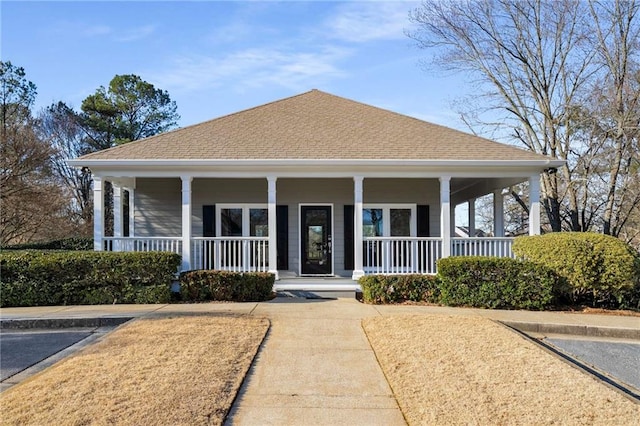 view of front of house with a porch and roof with shingles