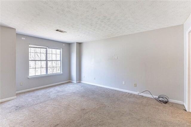 spare room featuring ceiling fan with notable chandelier, wood finished floors, visible vents, and baseboards