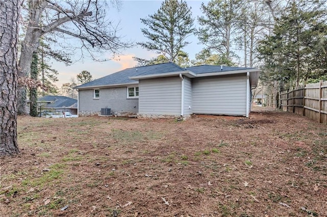 back of property featuring fence and cooling unit