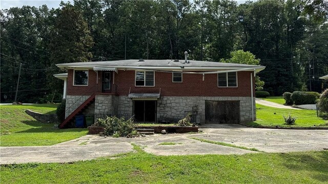 rear view of property featuring a yard