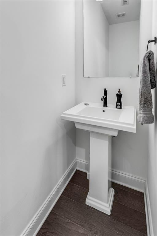 bathroom with hardwood / wood-style flooring