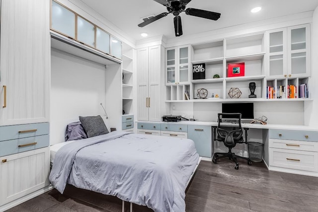 bedroom with ceiling fan, a closet, and dark wood-type flooring