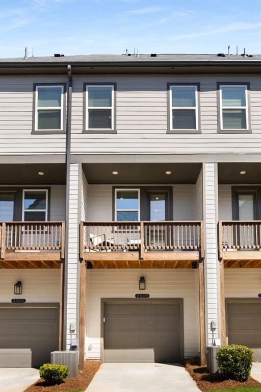 view of property with a balcony and a garage