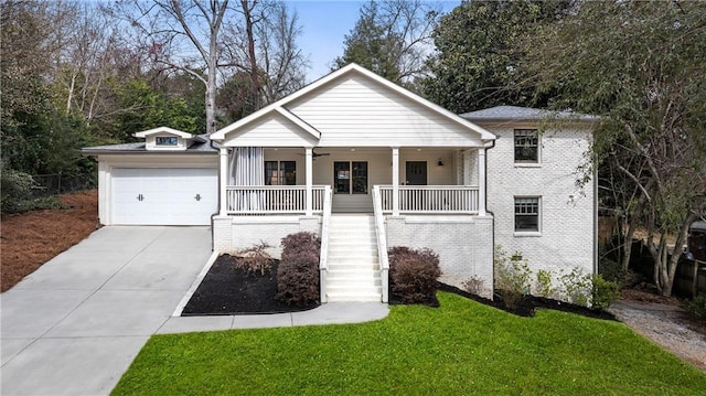 view of front of home with stairway, a porch, concrete driveway, and brick siding