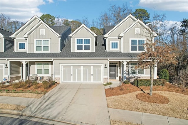 craftsman-style house with a porch, board and batten siding, concrete driveway, and roof with shingles