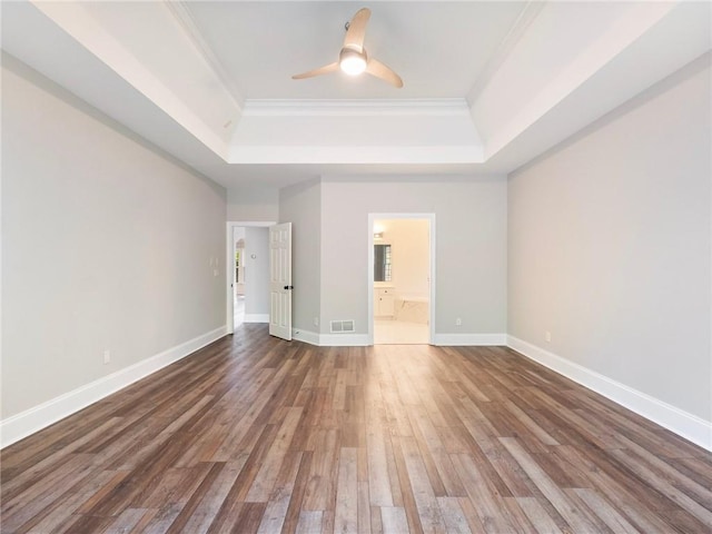 11405 Donnington Dr, Duluth, GA 30097 - spare room with a tray ceiling, wood finished floors, ornamental molding, and ceiling fan