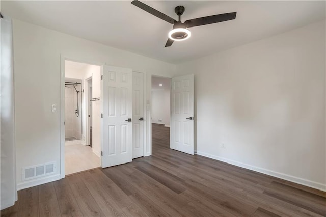 3480 Tanbark Ct NE, Brookhaven, GA 30319 - unfurnished bedroom with dark wood-type flooring, ensuite bathroom, and ceiling fan