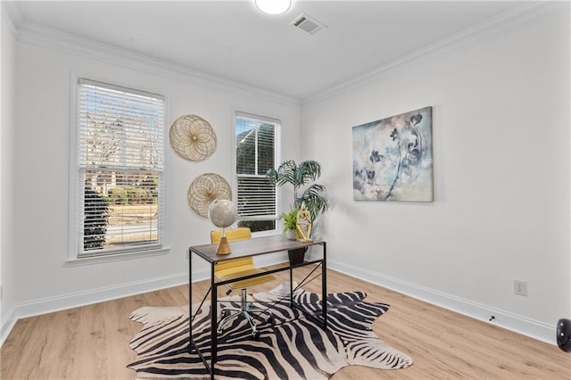 office area featuring crown molding, baseboards, wood finished floors, and visible vents