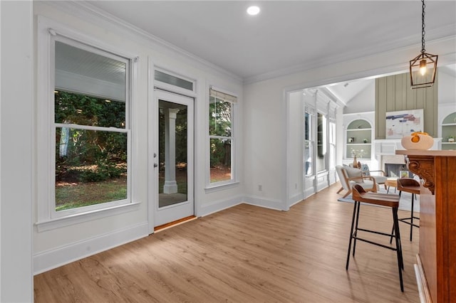 interior space with built in features, baseboards, light wood-type flooring, and lofted ceiling