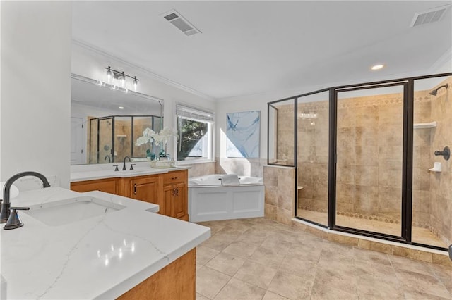 bathroom featuring vanity, a shower stall, visible vents, ornamental molding, and a garden tub