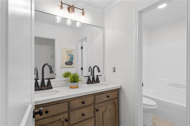 full bathroom with double vanity, crown molding, tile patterned flooring, a sink, and toilet