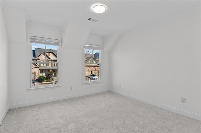 empty room featuring visible vents, carpet, and baseboards