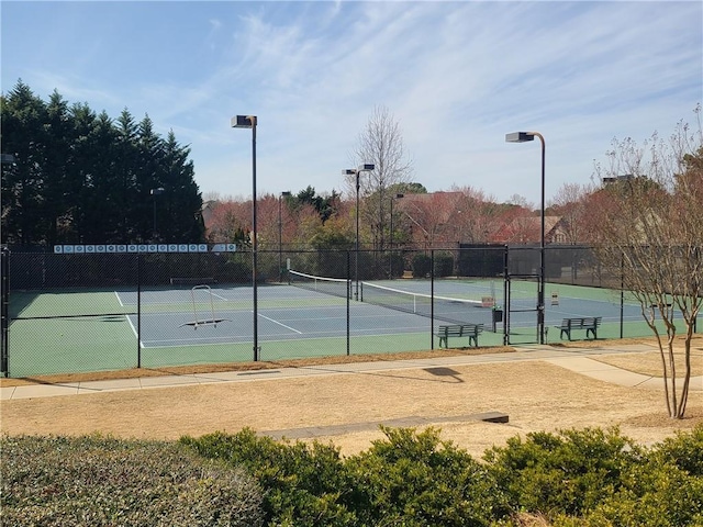 view of tennis court with fence