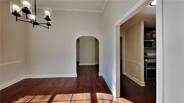 hall with dark hardwood / wood-style flooring, crown molding, and a chandelier