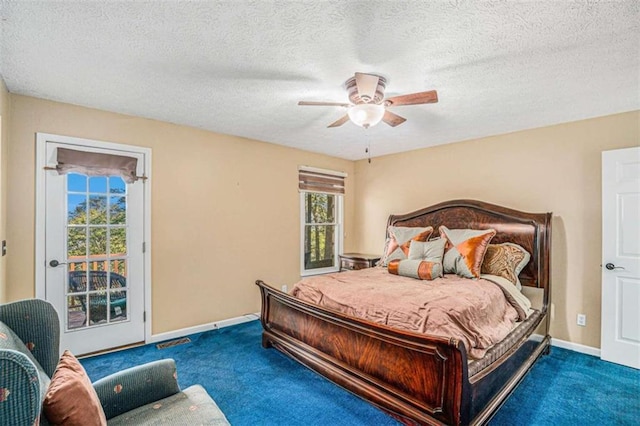 carpeted bedroom with ceiling fan, access to outside, and a textured ceiling