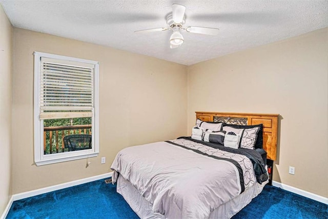 bedroom featuring a textured ceiling, carpet floors, and ceiling fan