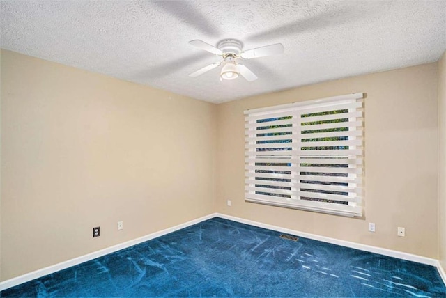 carpeted empty room with a textured ceiling and ceiling fan