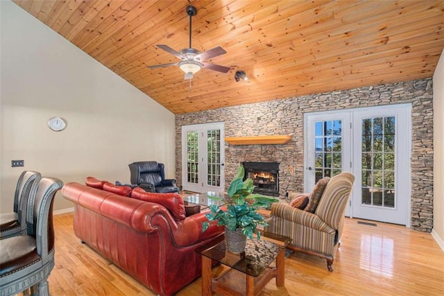 living room featuring light hardwood / wood-style floors, ceiling fan, a wealth of natural light, and wood ceiling