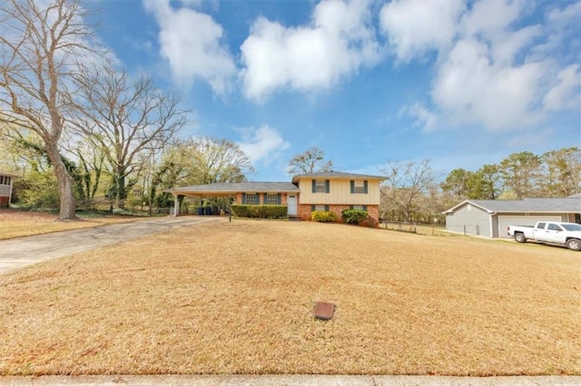 tri-level home featuring a carport, concrete driveway, and a front lawn