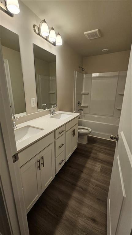 full bathroom featuring vanity, toilet, wood-type flooring, and bathing tub / shower combination