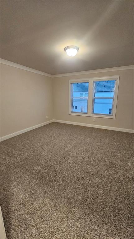 unfurnished room featuring crown molding