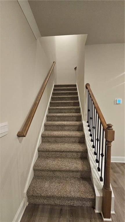 stairs with wood-type flooring