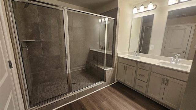 bathroom featuring vanity, wood-type flooring, and an enclosed shower