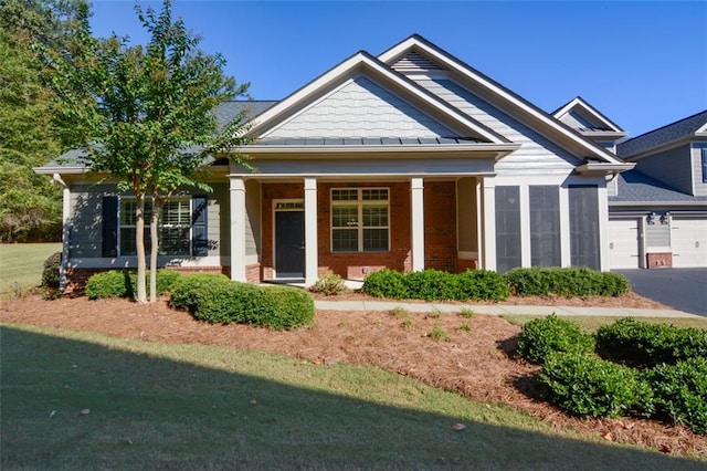 craftsman inspired home with covered porch and a garage