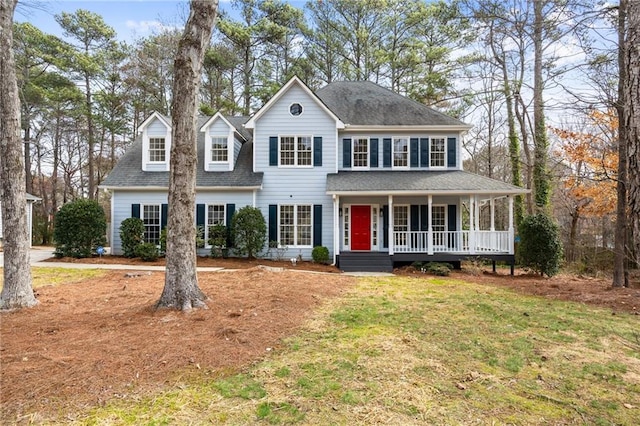 colonial-style house featuring a front lawn and covered porch