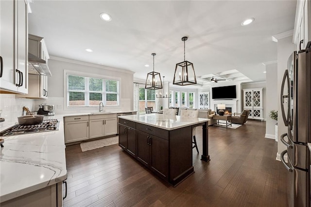 107 Equest Dr, Canton, GA 30115 - kitchen featuring appliances with stainless steel finishes, ornamental molding, open floor plan, tasteful backsplash, and dark brown cabinetry