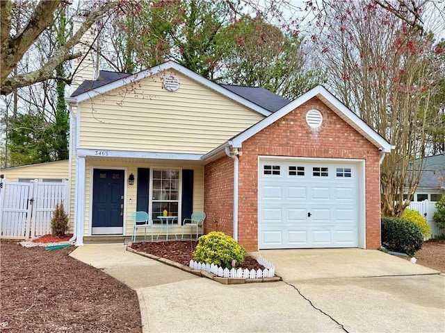 view of front of house featuring a porch, fence, concrete driveway, a garage, and brick siding