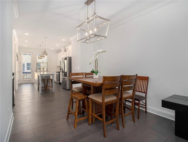 dining area featuring dark wood-type flooring, crown molding, and a chandelier