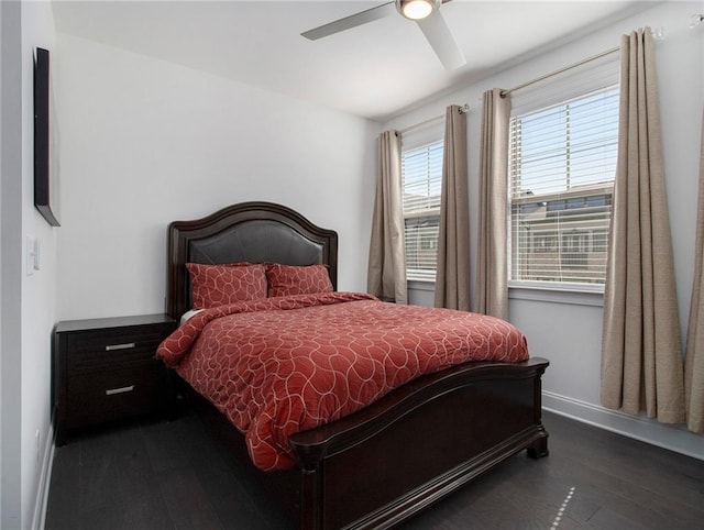 bedroom with ceiling fan and dark hardwood / wood-style floors