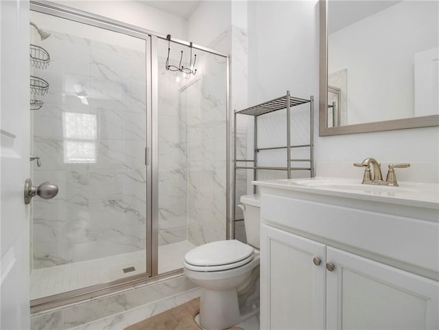 bathroom featuring tile patterned floors, a shower with shower door, vanity, and toilet