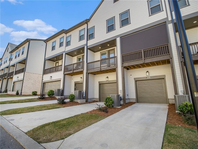 view of front of home with central AC, a balcony, and a garage