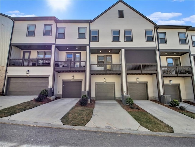 townhome / multi-family property featuring a balcony, a garage, and central AC