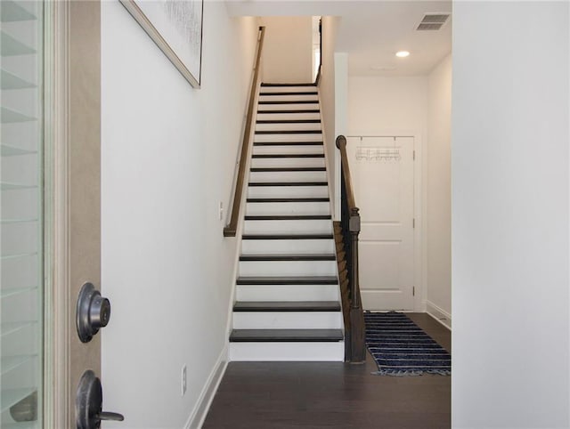 staircase featuring hardwood / wood-style flooring