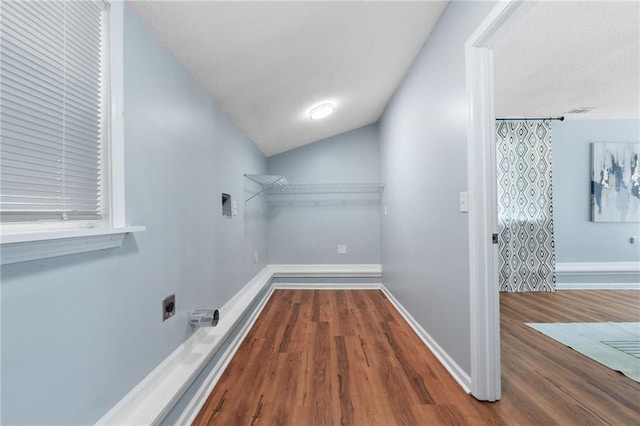 1694 Pheasant Dr, Atlanta, GA 30238 - laundry area featuring electric dryer hookup, wood finished floors, and a textured ceiling