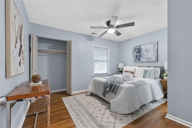 1694 Pheasant Dr, Atlanta, GA 30238 - bedroom featuring a closet, wood finished floors, a textured ceiling, and a ceiling fan
