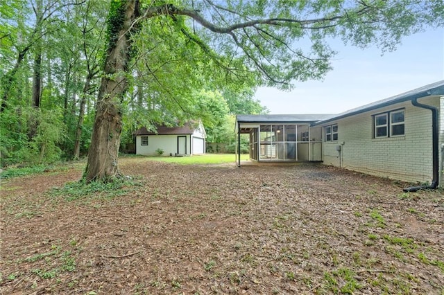1694 Pheasant Dr, Atlanta, GA 30238 - view of yard featuring a sunroom and an outdoor structure