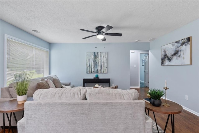 1694 Pheasant Dr, Atlanta, GA 30238 - living room with dark wood finished floors, a textured ceiling, and a ceiling fan