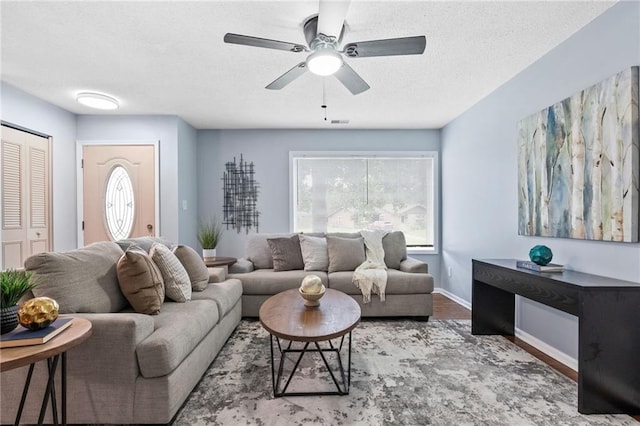 1694 Pheasant Dr, Atlanta, GA 30238 - living room with a ceiling fan, a textured ceiling, wood finished floors, and plenty of natural light